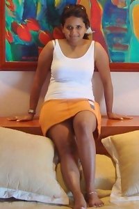 an asian girl laying on a bed and sucking her fingers